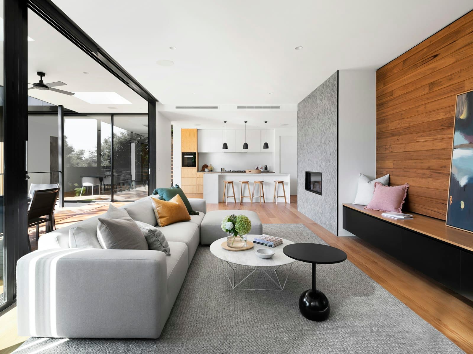 Open-concept living and kitchen renovation with warm wood and large glazing