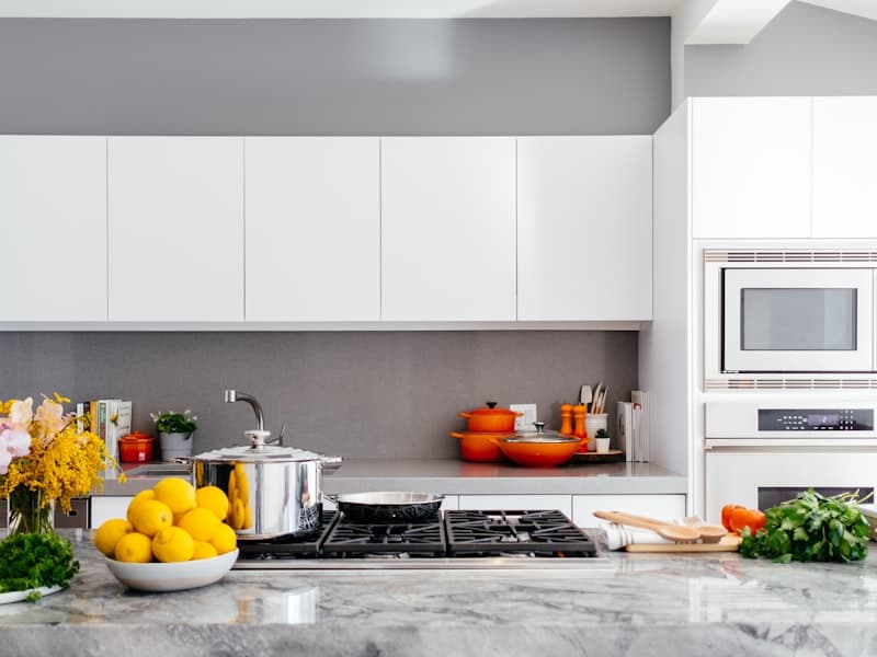 Bright white kitchen remodel with a Calacatta marble island and gas range